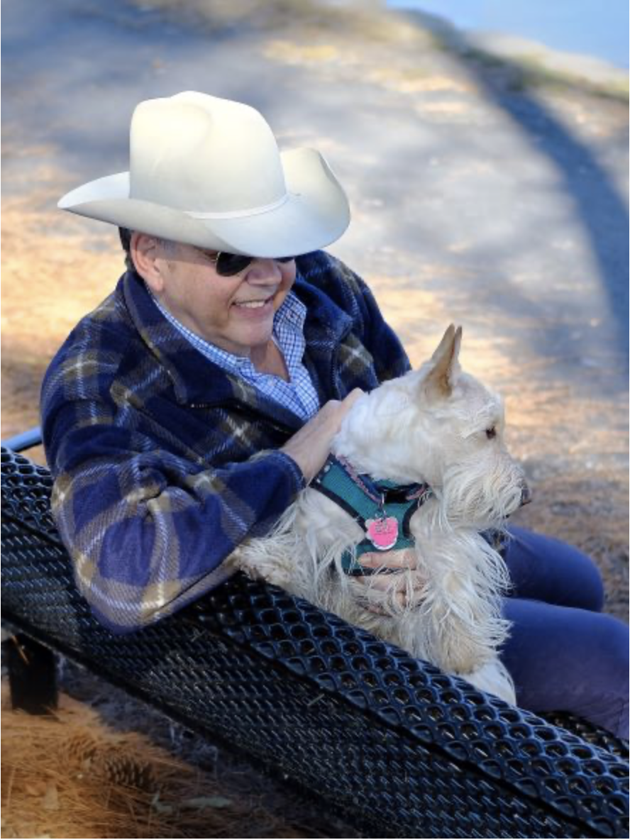 Bob and his emotional support dog Doppler sitting together on a park bench