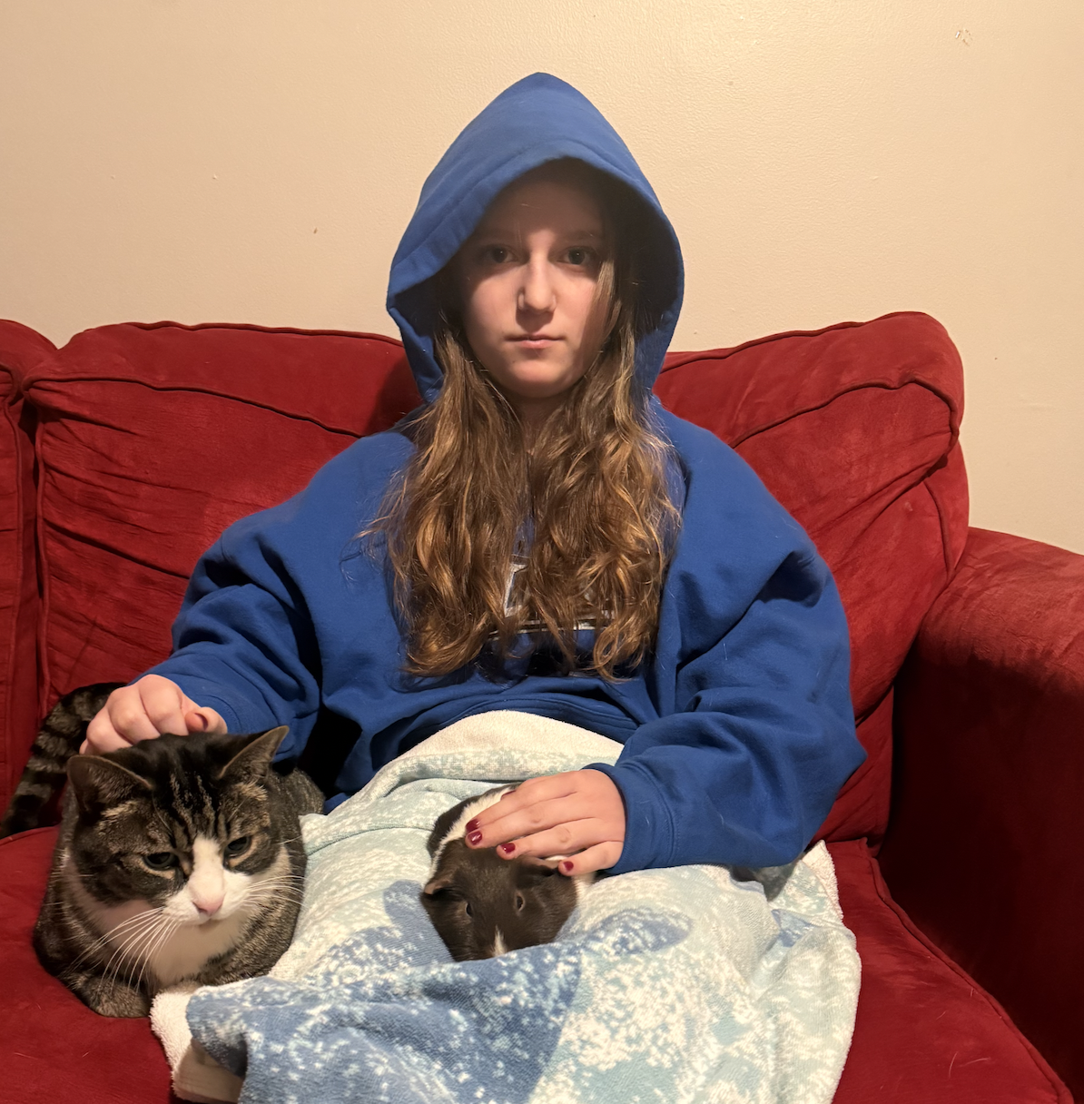 Woman holding her cat and guinea pig