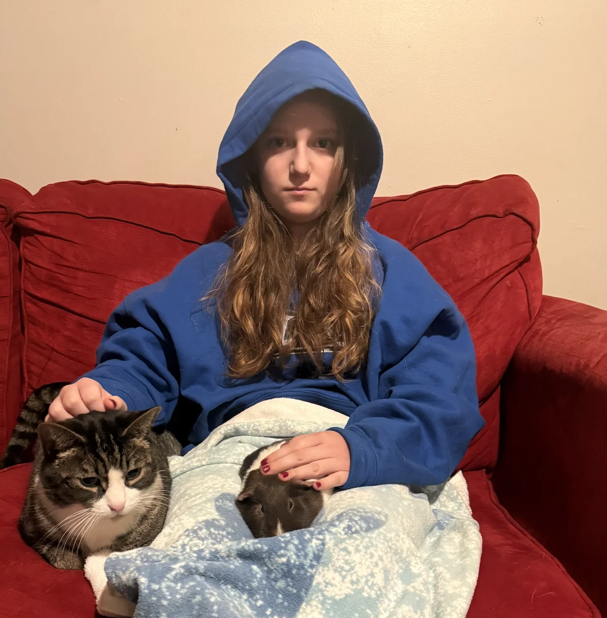Woman holding her cat and guinea pig