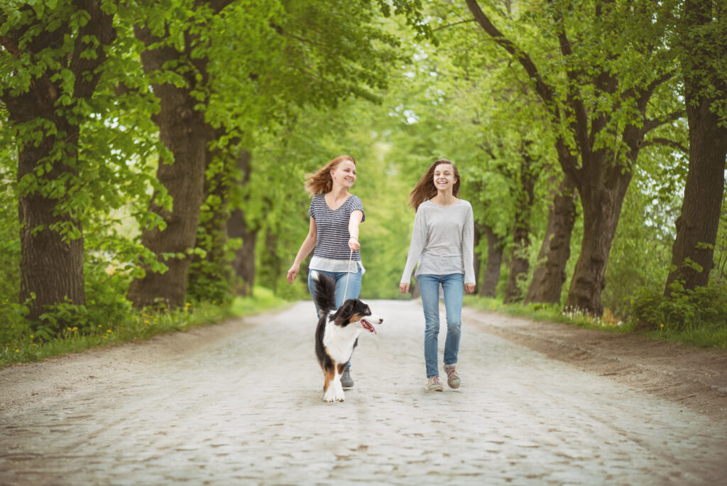 Happy woman walking with her ESA dog and another woman